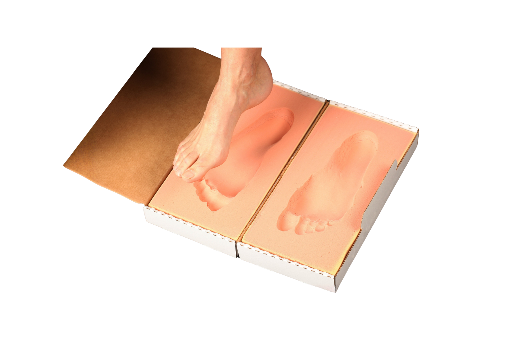 A traditional foam-box impression — a foot pressed into casting foam to mould a static orthotic
